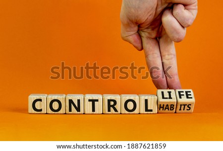 Control habits symbol. Businessman hand turns wooden cubes and changes words 'control habits' to 'control life'. Beautiful orange background, copy space. Business and control habits concept. Foto stock © 
