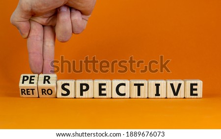 Perspective or retrospective symbol. Businessman hand turns cubes and changes word 'retrospective' to 'perspective'. Beautiful white background. Business and perspective concept. Copy space.