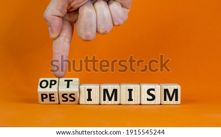 Pessimism or optimism symbol. Businessman turns cubes and changes the word 'pessimism' to 'optimism'. Beautiful orange table, orange background. Business and optimism or pessimism concept. Copy space. Сток-фото © 