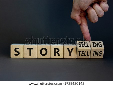Storytelling or storyselling symbol. Businessman turns wooden cubes and changes the word 'storytelling' to 'storyselling'. Beautiful grey background, copy space. Business and storytelling concept. Stock foto © 