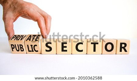 Private or public sector symbol. Businessman turns cubes and changes words 'public sector' to 'private sector'. Beautiful white background, copy space. Business, private or public sector concept. Imagine de stoc © 