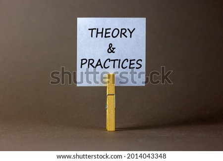 Theory and practice symbol. White paper with words 'Theory and practice', clip on wooden clothespin. Beautiful grey background. Business, theory and practice concept. Copy space.