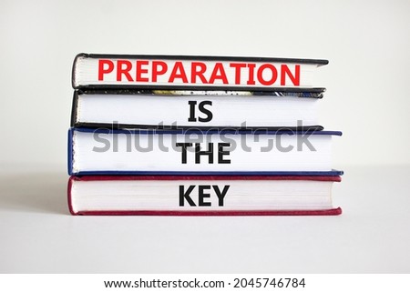 Preparation is the key symbol. Books with words 'Preparation is the key'. Businessman hand. Beautiful white background, copy space. Business and preparation is the key concept. ストックフォト © 
