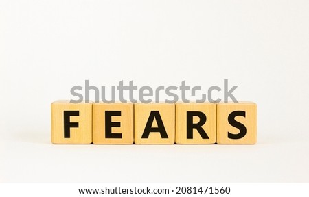 Fears symbol. The concept word 'fears' on wooden cubes. Beautiful white table, white background, copy space. Business, psychological and fears fear concept.
