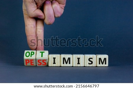 Pessimism or optimism symbol. Businessman turns cubes and changes the word 'pessimism' to 'optimism'. Beautiful grey table, grey background. Business, optimism or pessimism concept. Copy space. ストックフォト © 