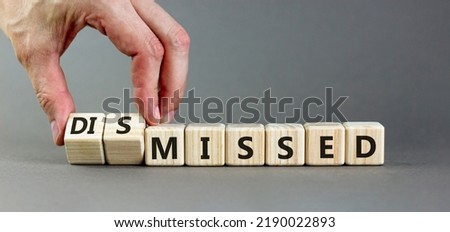 Missed or dismissed symbol. Businessman turns cubes and changes the word 'missed' to 'dismissed'. Beautiful grey background, copy space. Business, missed or dismissed concept. Foto stock © 