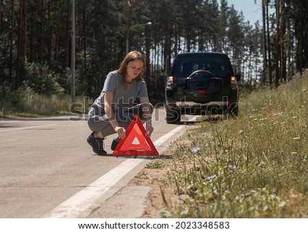 Similar – Foto Bild Fahrer stellt rotes Dreieck in der Nähe des kaputten Autos auf