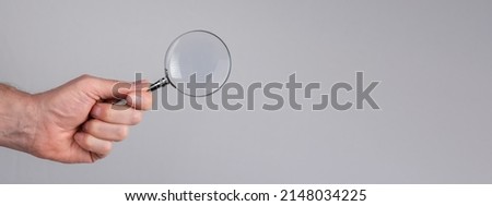 Banner with man hand with magnifying glass. Data search analysis, conducting research, nuances, important details study, preparation for exams concept. Space for text. High quality photo Imagine de stoc © 