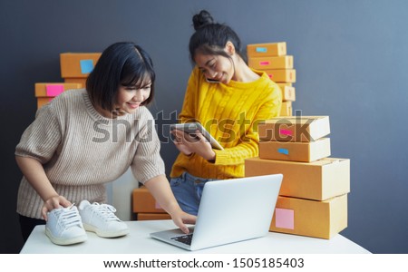 Startup small business owner working with computer at workplace. Freelance two woman seller check product order. Packing goods for delivery to customer. Online selling. E-commerce. Online Shopping 商業照片 © 