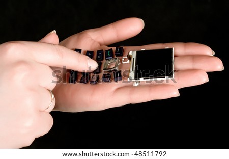 mobil telephone in women  hands with  black background