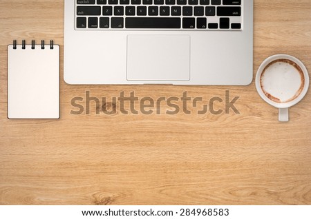 office desk top view with blank space on wood background