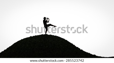 silhouette man kick boxing on hill