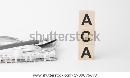 aca inscription on wooden cubes isolated on white background, medicine concept. Nearby on the table are a stethoscope and pills. Imagine de stoc © 