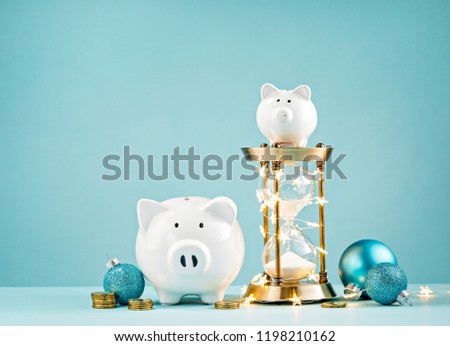 Iconswebsite Com Icons Website Search Over 28444869 Icons Icon - piggy banks christmas decorations and hourglass wrapped in lights on a blue background
