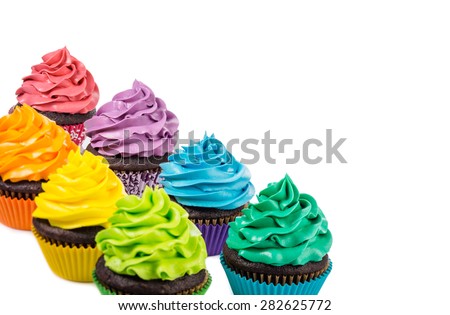 Chocolate cupcakes with colourful icing on a white background.