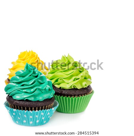 Chocolate cupcakes arranged with colorful icing on a white background.