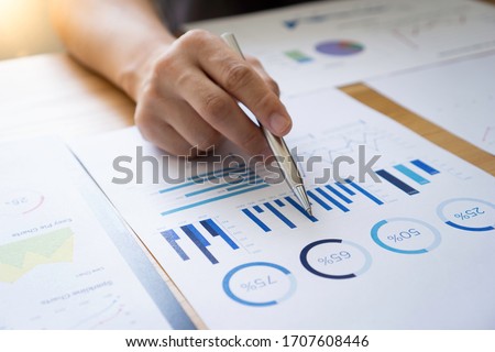 Asian male finance staff Is explaining the performance from the company's rapidly growing bar graph this year. To his boss On the desk at the office, Finance concept Сток-фото © 
