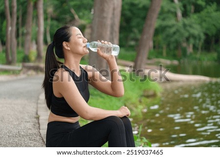 Similar – Image, Stock Photo Slim sportswoman drinking water in park