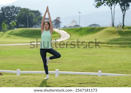 Similar – Image, Stock Photo Flexible young sportswoman practicing yoga on street