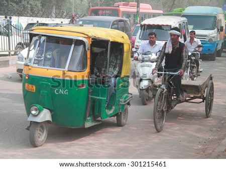DELHI, INDIA - FEBRUARY 18, 2015: people ride different transport in some poor district of Delhi, India