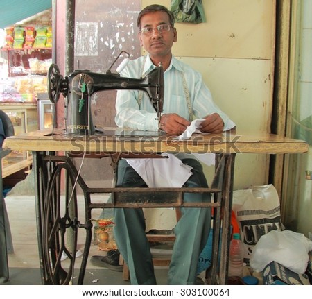 MUMBAI, INDIA - FEBRUARY 28, 2015: man is working with sewing machine in Mumbai, India