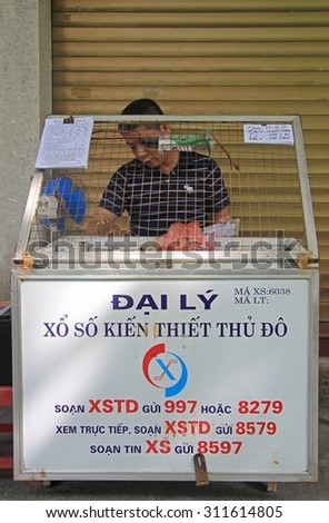 HANOI, VIETNAM - JUNE 2, 2015: man sells lottery tickets on street in Hanoi
