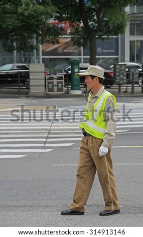 SHANGHAI, CHINA - JULY 2, 2015: traffic officer are controling street motion in Shanghai