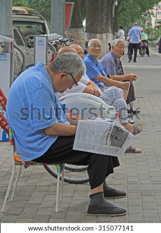 BEIJING, CHINA - JULY 4, 2015: some old people are relaxing on the street in Beijing, China