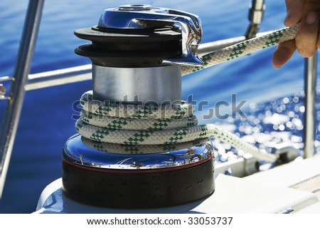 A photo of a wet rope on a boat winch being pulled in