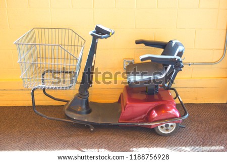 Image, Stock Photo Electric scooter with shopping bags and woman in background.