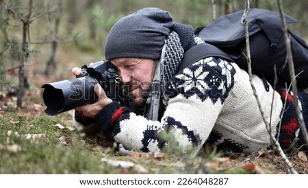 Similar – Man photographing landscape from observation deck