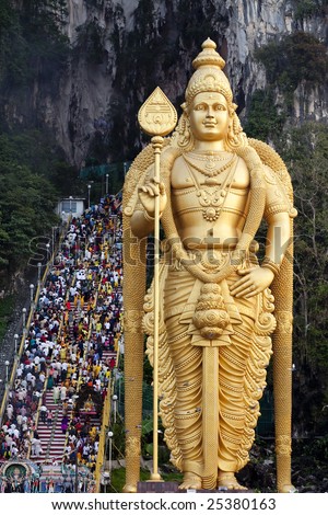 Thousands of Hindu Tamil Indians climbing steps to Batu Caves alongside statue of Lord Murugan in Kuala Lumpur, Malaysia for Thaipusam