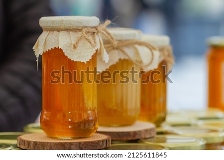 Organic honey jar with plastic lid tied with string, organic farming concept. Foto stock © 
