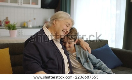 A child visiting his grandmother during the feast (Ramadan or Şeker Bayram). People who adhere to Muslim traditions. Child hugs his grandmother, happy to see each other, celebrates traditional holiday Foto stock © 