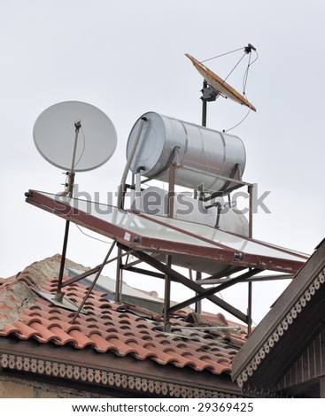Satellite dishes and solar technology crammed onto a rooftop