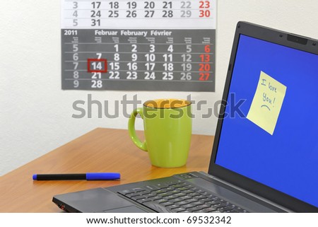 Love note on computer screen symbolizing office romance concept