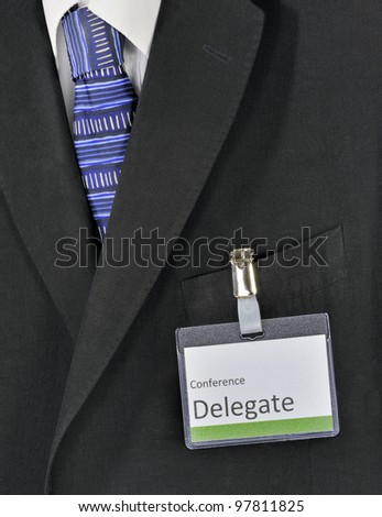 Closeup on male business suit and conference delegate badge