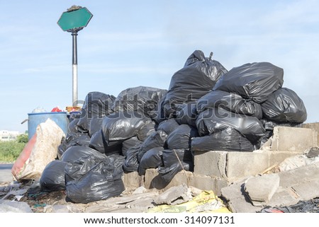 pollution and Disorganized grablage Garbage Disposal and pile of black bags garbage prepare waste disposal, bangkok, thailand