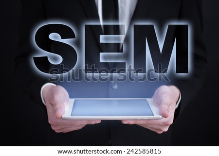 businessman holding a tablet with the projection of internet marketing concept. online marketing. digital marketing. SEO, SEM, SMM.
