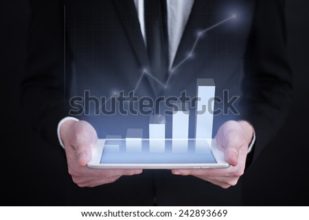 businessman holding a tablet PC with the projection of graph. investment concept.  financial growth. char. data analysis. statistics
