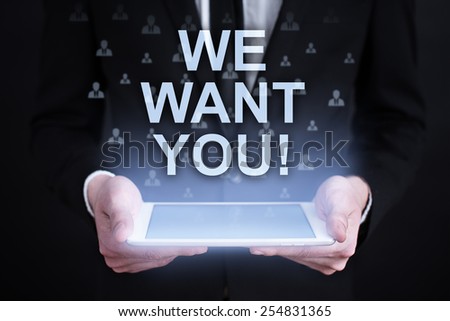 businessman holding a tablet with we want you text and recruitment concept on the screen. Internet concept. business concept.