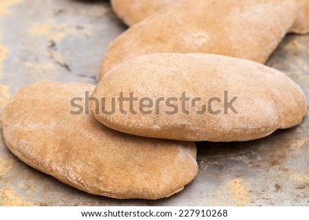 Loaves of traditional Egyptian homemade brown pita bread, fresh from the oven. called aish baladi