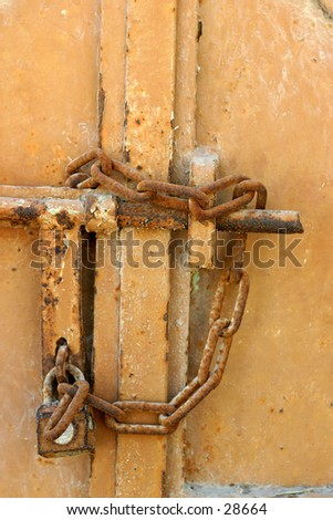 Locked up and gone away - and old gate secured by a rusty padlock