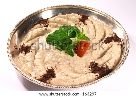 Traditional Arab eggplant dip, muttabel, topped with mint and a cut cherry tomato