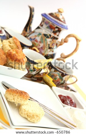 Traditional English cream tea, with scones (biscuits), jam, cream and tea.