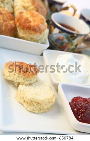 Traditional British cream tea with scones, cream, strawberry jam and tea. An afternoon treat.