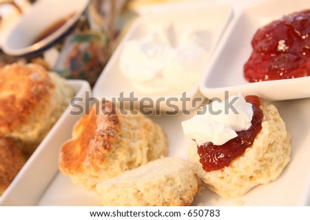 A traditional British cream tea, with scones, jam, cream and a cup of tea