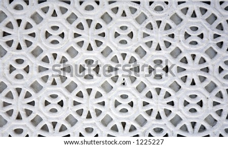 An example of Islamic design cast in concrete on a building in Doha, Qatar, crudely painted white. As Islam bans the depiction of human or animal forms, artists developed their style using shapes.