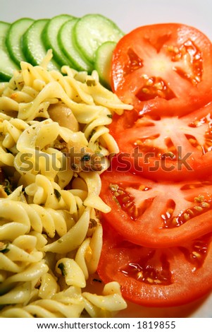 Fusillini pasta, cooked with mushrooms, frankfurter sausage slices, herbs and olive oil, served with cucumber and tomato slices
