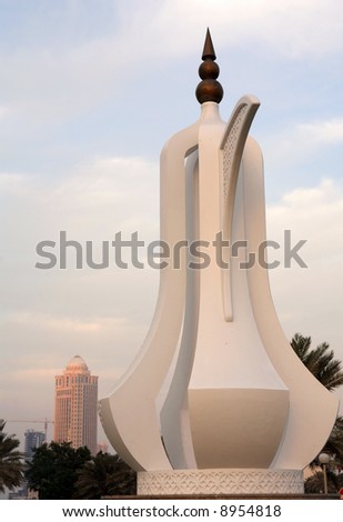 The coffeepot (dallah) monument on the Corniche in Doha, Qatar, with the Four Seasons Hotel out of focus behind it.